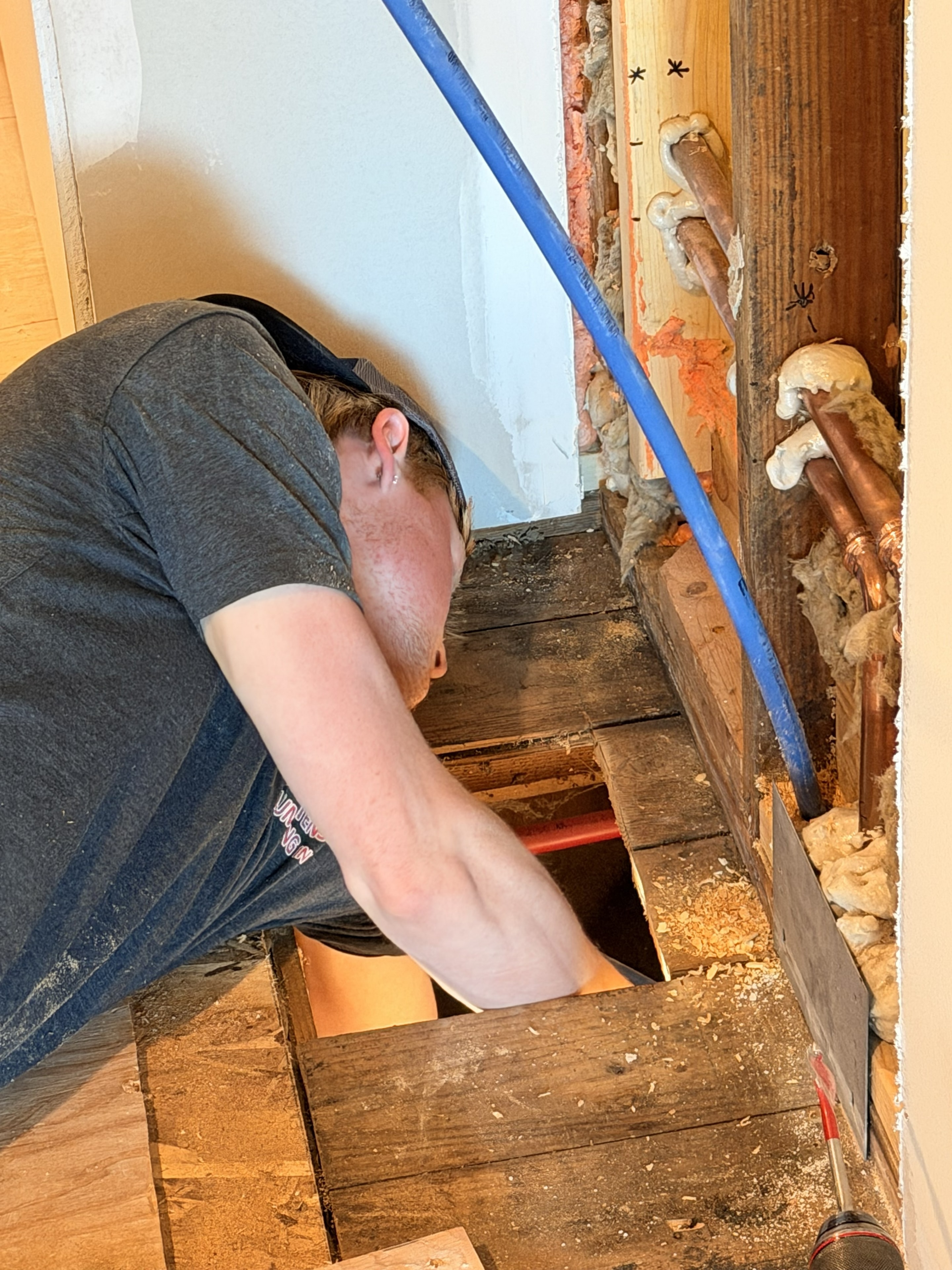 Plumber servicing a water heater